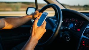 Person texting on phone while driving