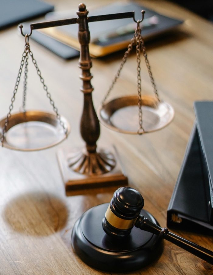 Lawyers office with scales of justice and gavel on desk